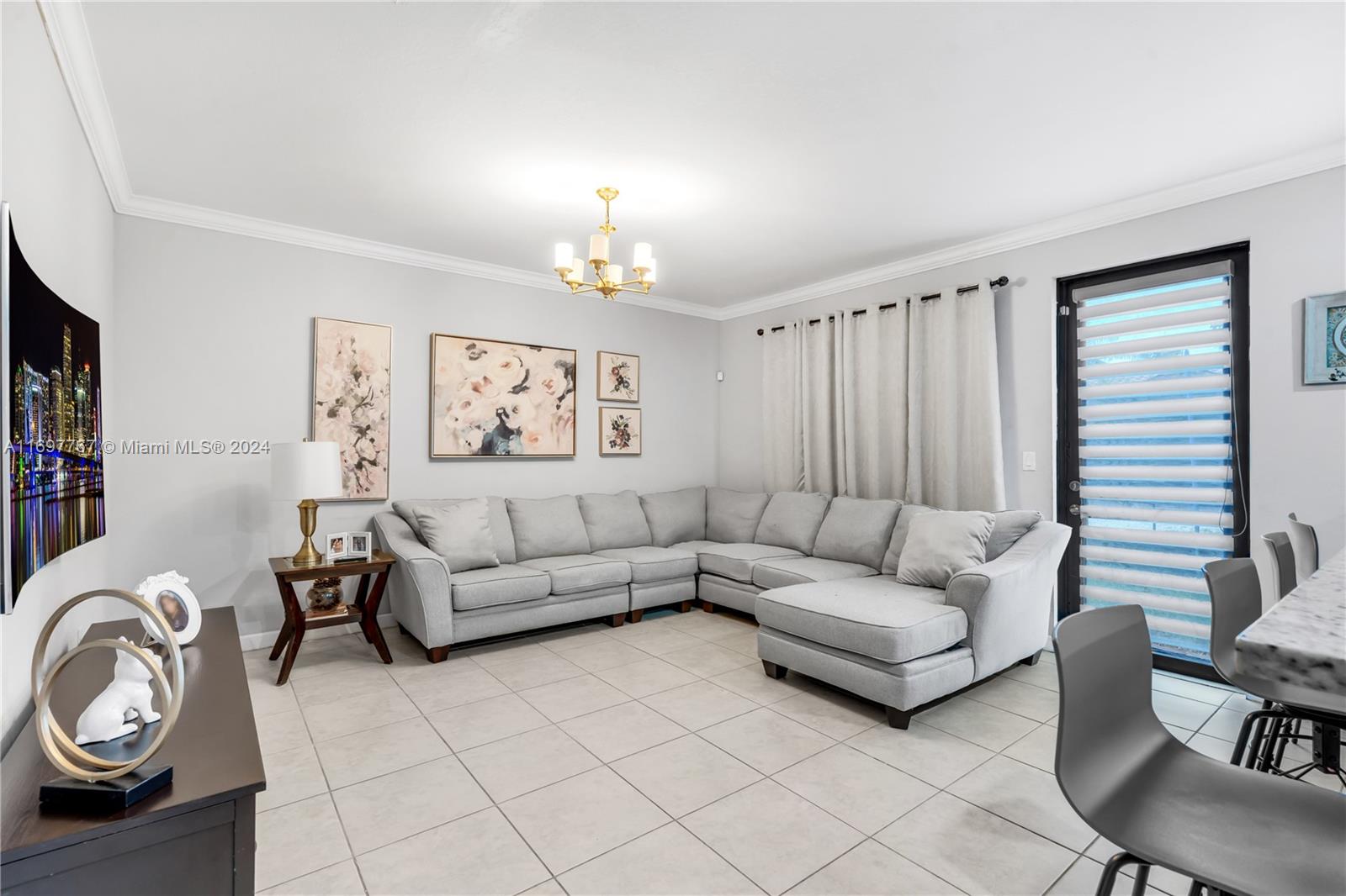 17403 Southwest 155th Court Miami, FL 33187 - Photo 11 of 42 a living room with furniture a fireplace and a window