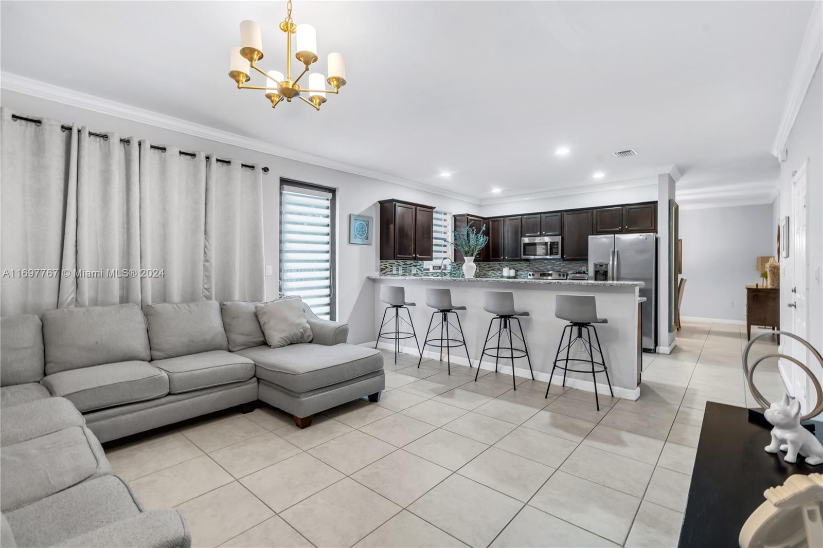 17403 Southwest 155th Court Miami, FL 33187 - Photo 12 of 42 a living room with furniture and a flat screen tv
