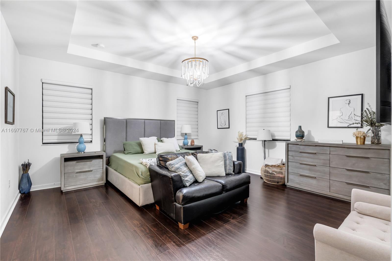 17403 Southwest 155th Court Miami, FL 33187 - Photo 14 of 42 a spacious bedroom with a bed and a couch