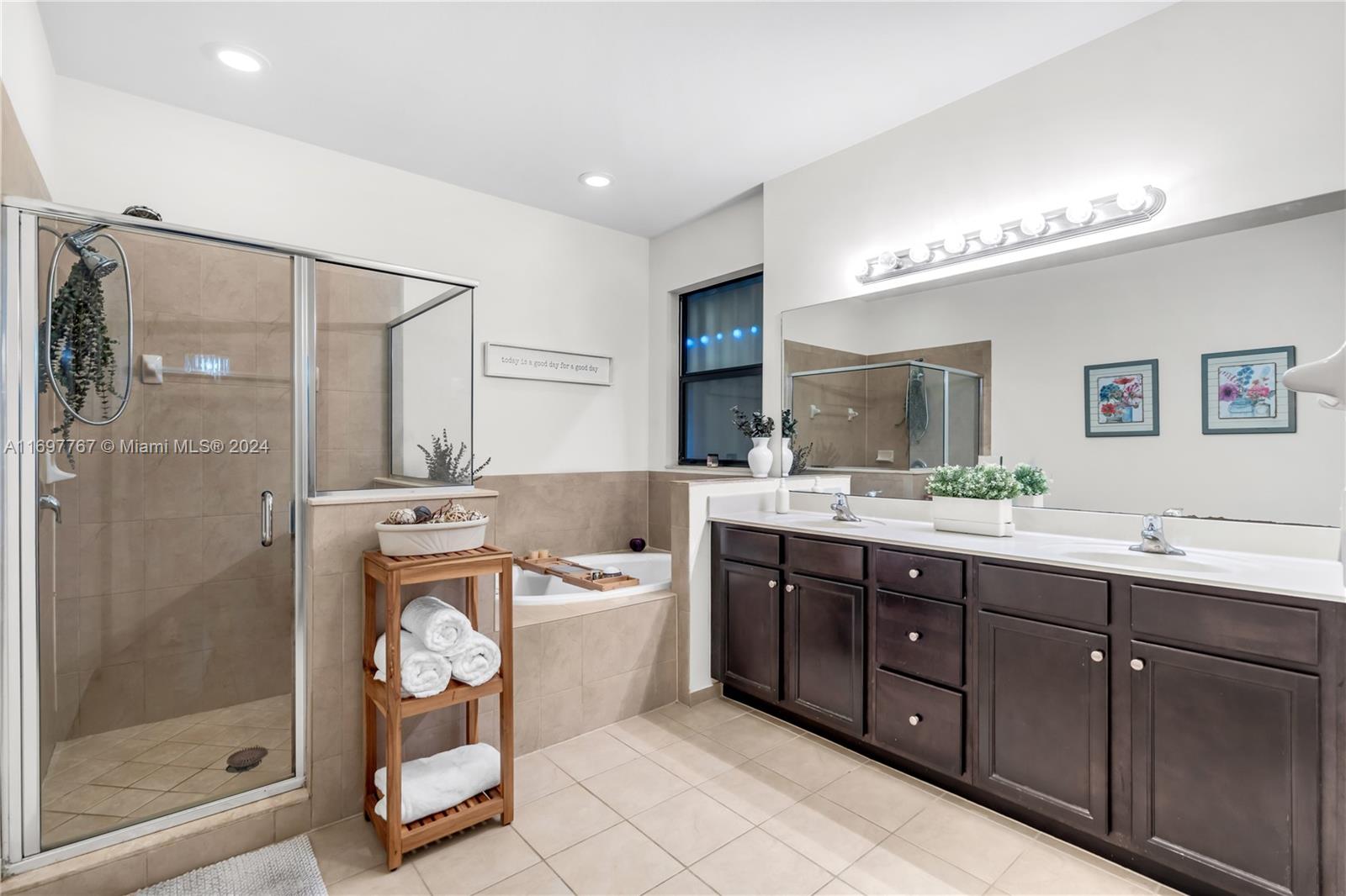 17403 Southwest 155th Court Miami, FL 33187 - Photo 18 of 42 a bathroom with a double vanity sink mirror and bathtub