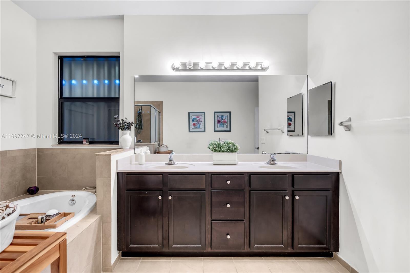 17403 Southwest 155th Court Miami, FL 33187 - Photo 21 of 42 a bathroom with a sink double vanity and a mirror