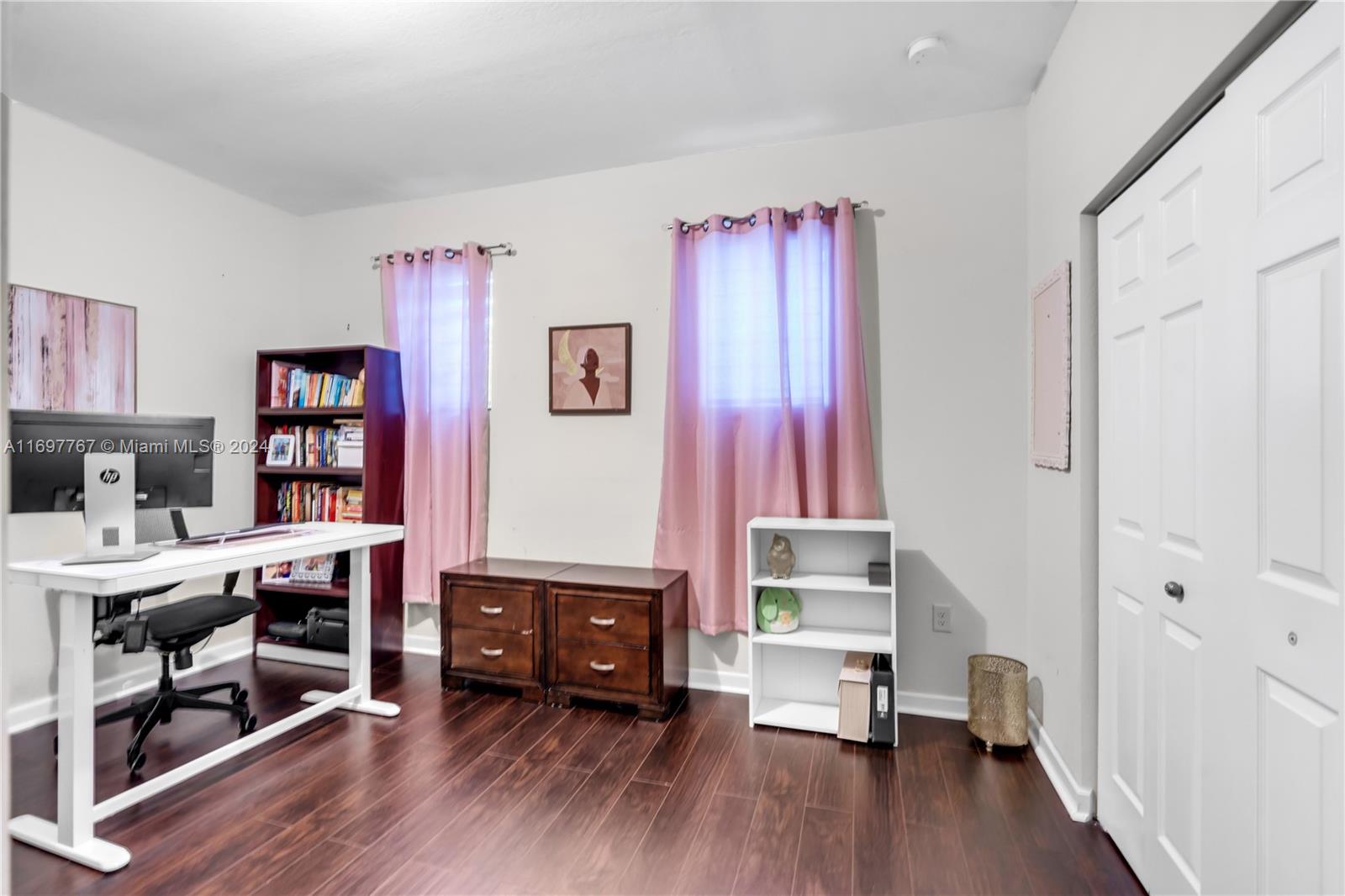 17403 Southwest 155th Court Miami, FL 33187 - Photo 22 of 42 a view of a workspace with furniture and wooden floor