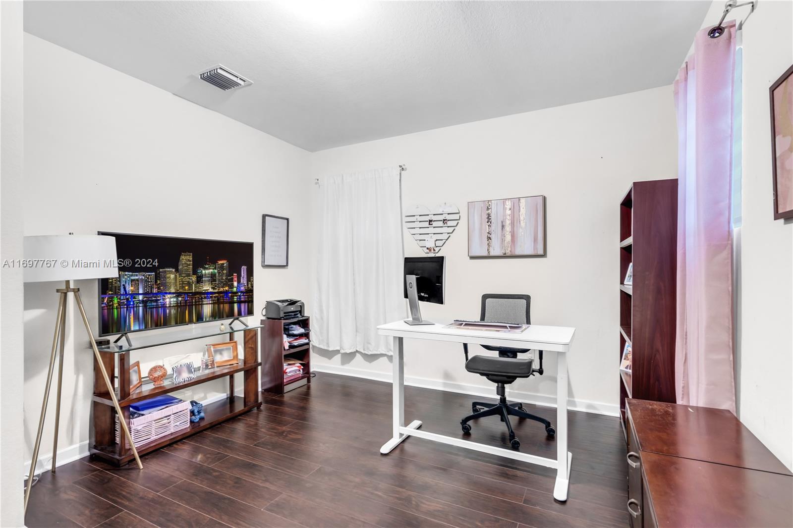 17403 Southwest 155th Court Miami, FL 33187 - Photo 23 of 42 a bedroom with furniture and wooden floor
