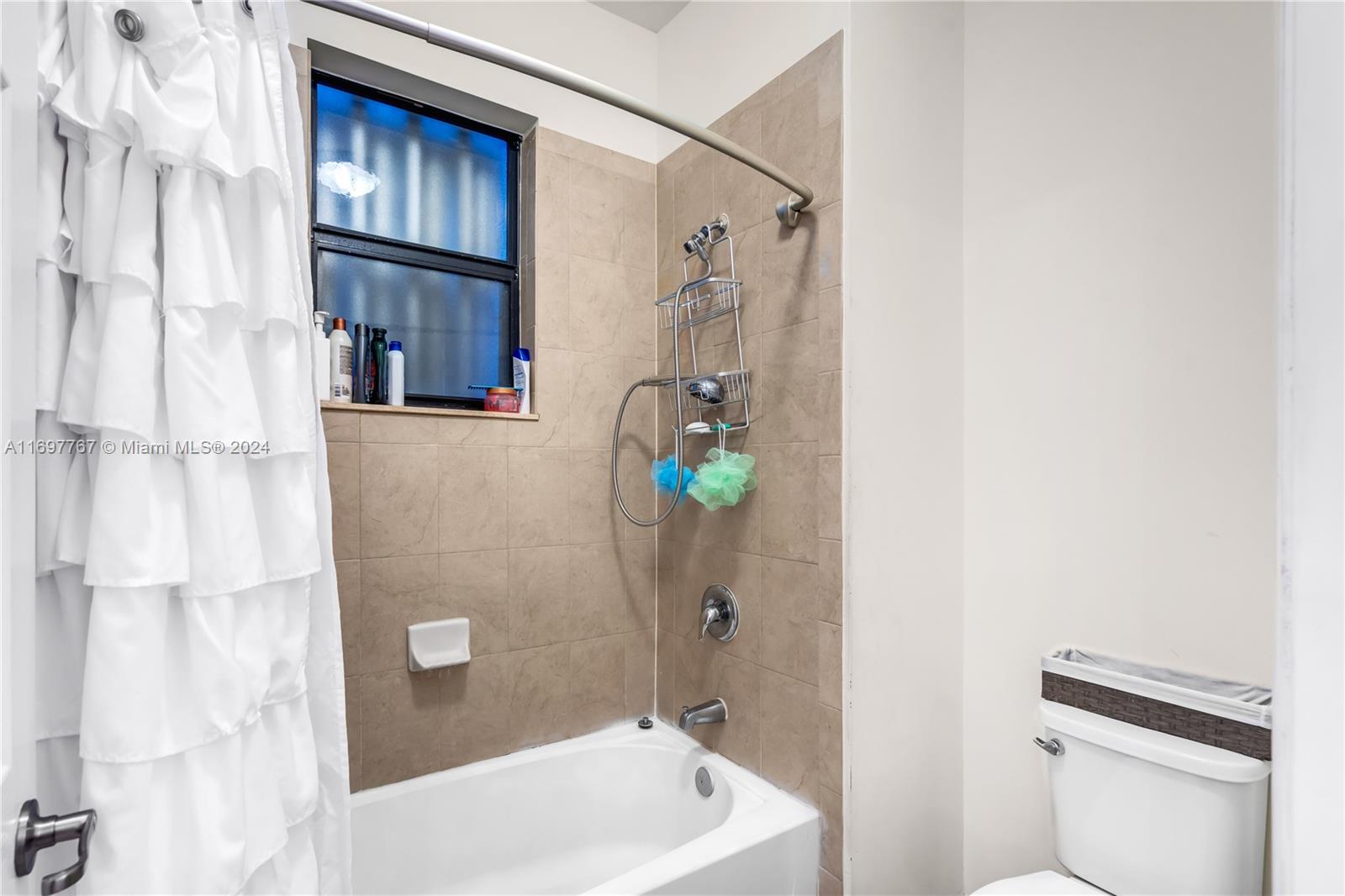 17403 Southwest 155th Court Miami, FL 33187 - Photo 25 of 42 a bathroom with a sink a toilet and shower