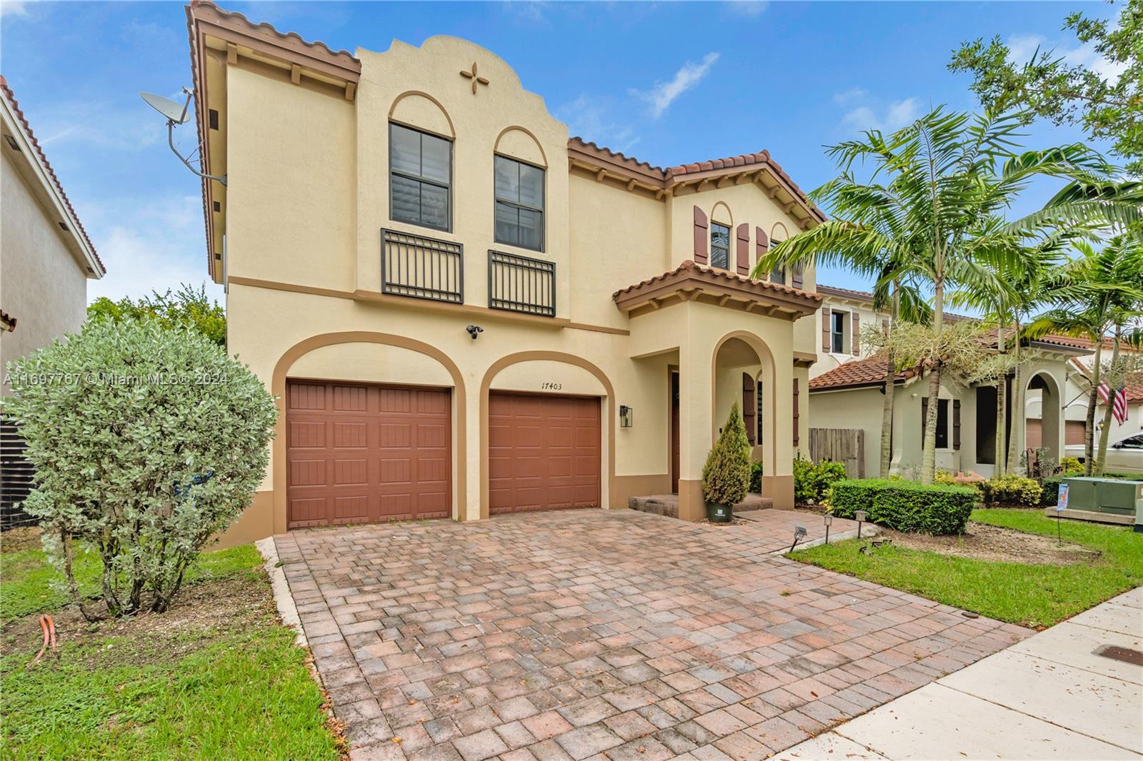 17403 Southwest 155th Court Miami, FL 33187 - Photo 4 of 42 front view of a brick house with a yard