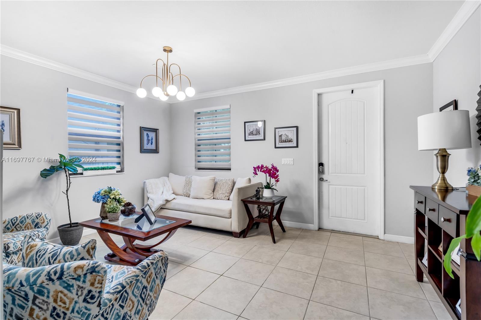 17403 Southwest 155th Court Miami, FL 33187 - Photo 6 of 42 a living room with furniture and a chandelier