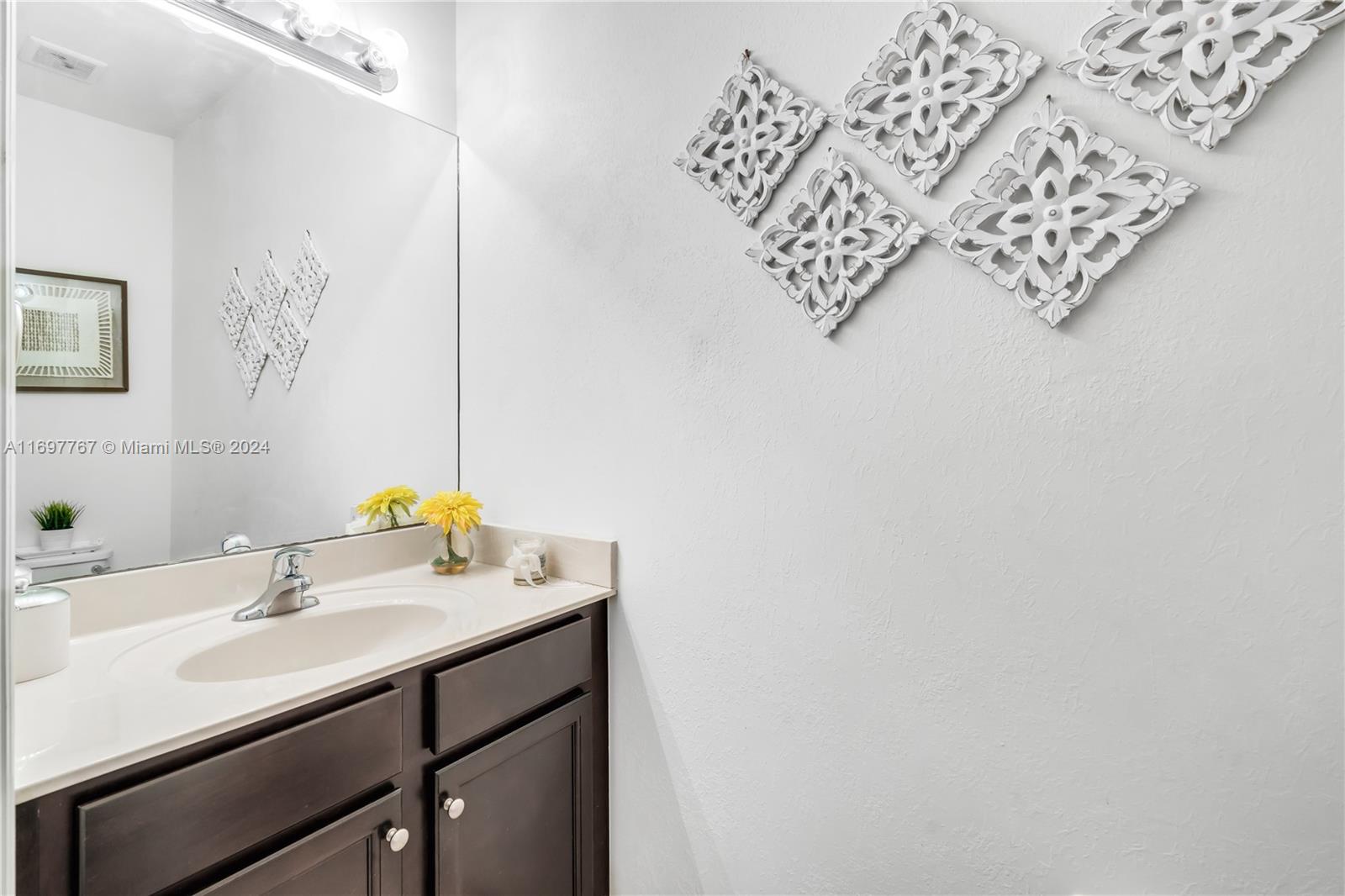 17403 Southwest 155th Court Miami, FL 33187 - Photo 7 of 42 a bathroom with a sink and a mirror
