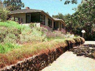 26 Turnagain Road Kentfield, CA 94904 - Photo 1 of 1 a view of a house with a yard and covered with trees