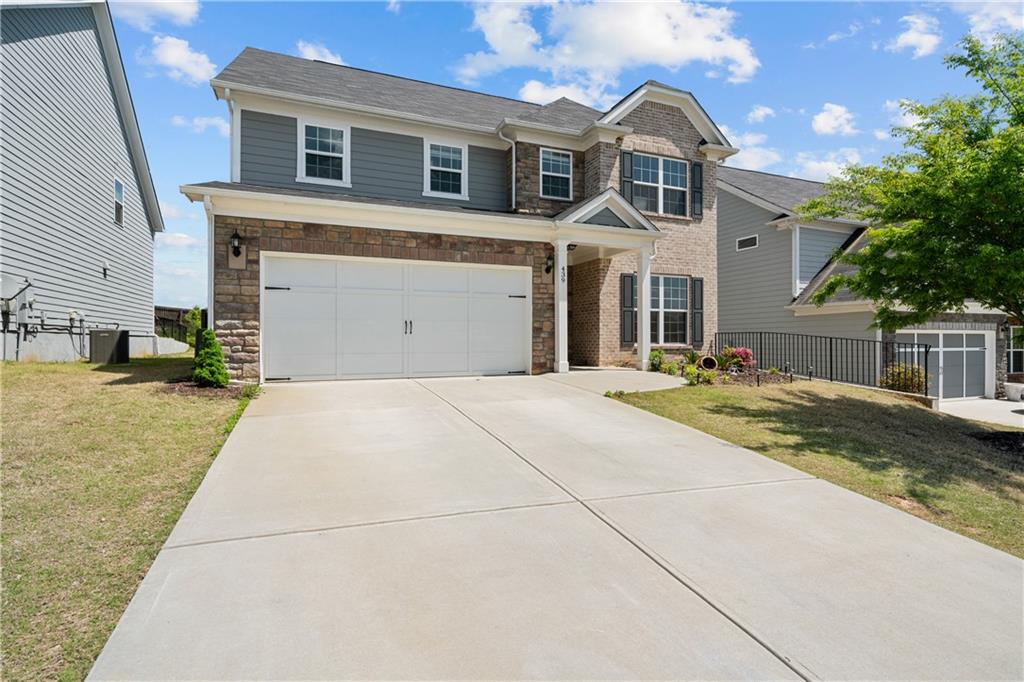 439 Timberleaf Road Holly Springs, GA 30115 - Photo 1 of 1 a front view of a house with a yard