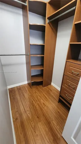 a view of walk in closet with empty racks
