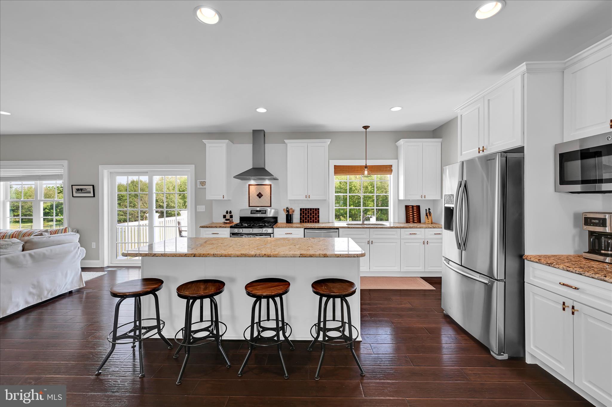 678 Integrity Drive Lititz, PA 17543 - Photo 6 of 51 a kitchen with stainless steel appliances granite countertop a table chairs refrigerator microwave and a sink