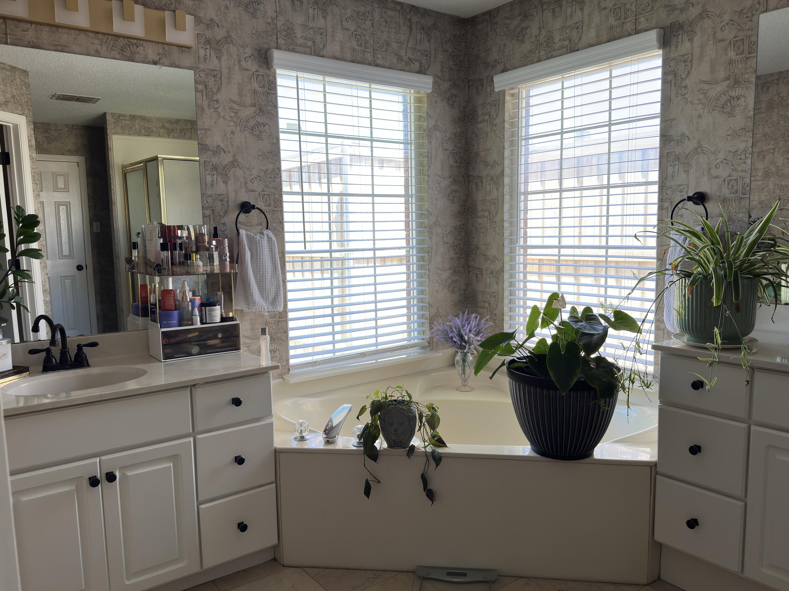 4902 103rd Street Lubbock, TX 79424 - Photo 19 of 23 a bathroom with a tub sink and mirror