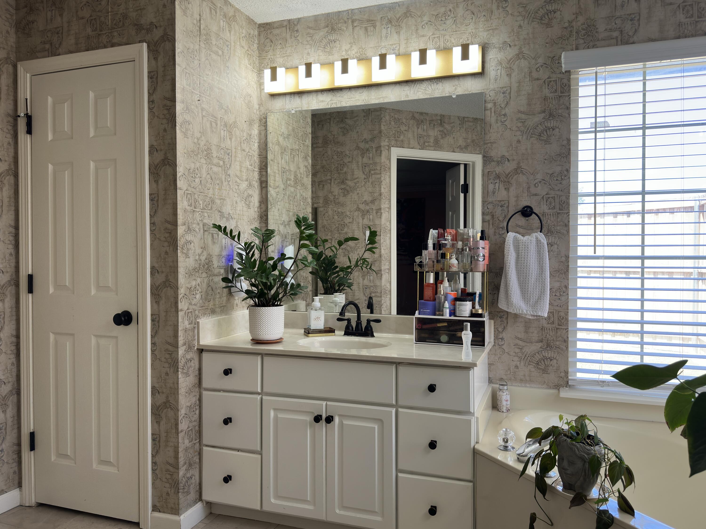 4902 103rd Street Lubbock, TX 79424 - Photo 22 of 23 a bathroom with a sink and a mirror