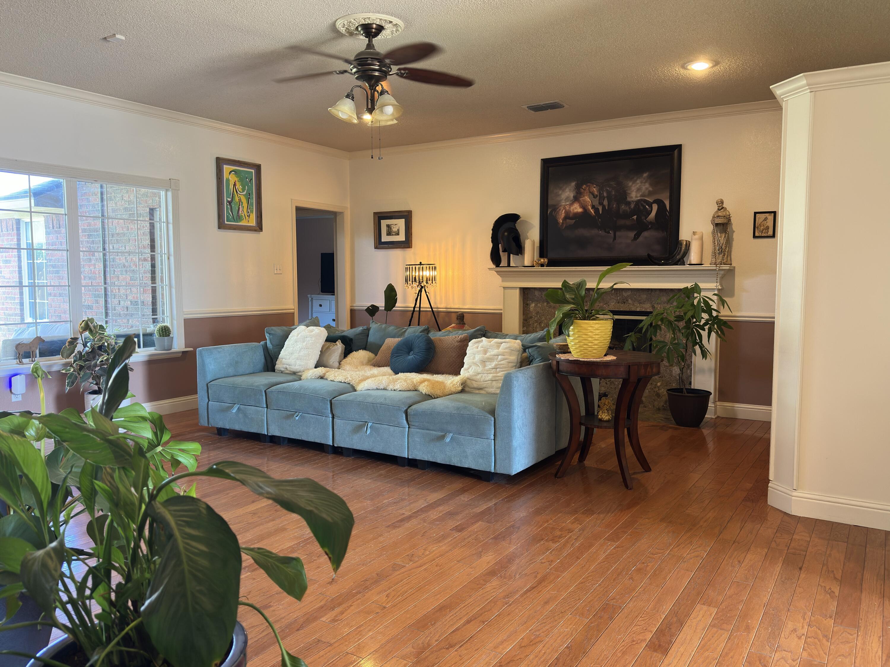 4902 103rd Street Lubbock, TX 79424 - Photo 8 of 23 a living room with furniture and a flat screen tv
