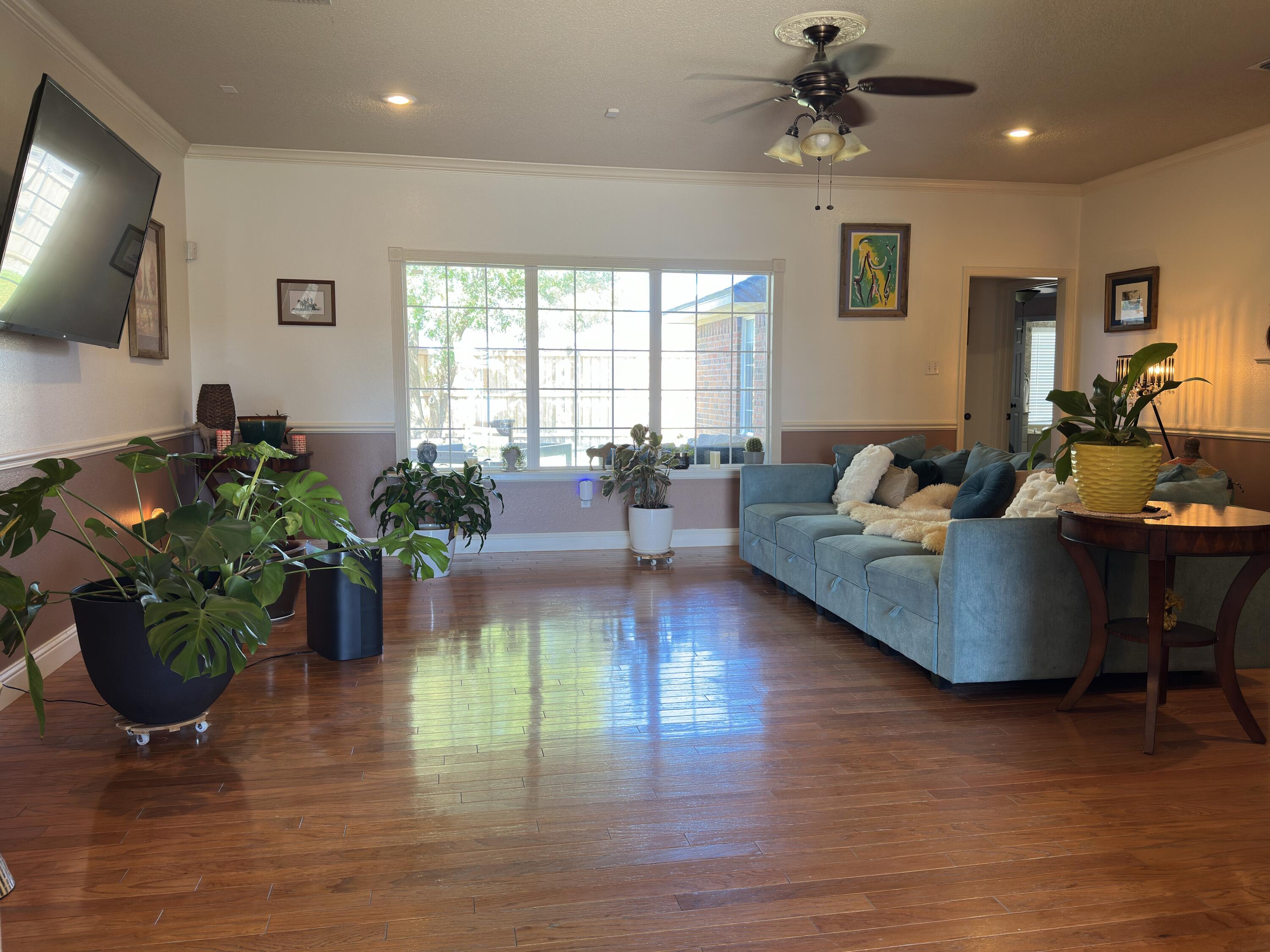 4902 103rd Street Lubbock, TX 79424 - Photo 9 of 23 a living room with furniture dining room and wooden floor
