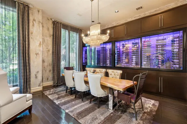 a dining room with furniture a chandelier and wooden floor