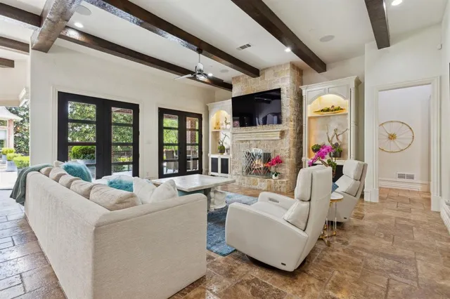 a living room with furniture a flat screen tv and a large window