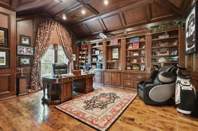 a living room with fireplace furniture and a rug