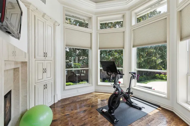 a view of a room with gym equipment and floor to ceiling windows