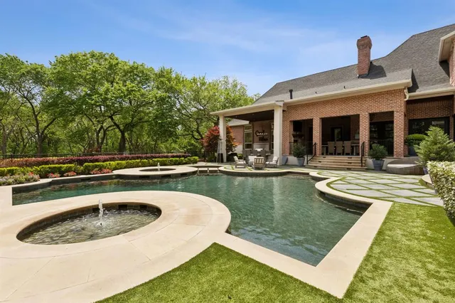 a view of a house with swimming pool and sitting area