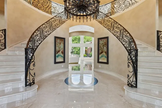 a view of an entryway with a floor to ceiling window and stairs