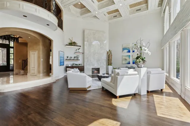 a living room with fireplace furniture and a wooden floor