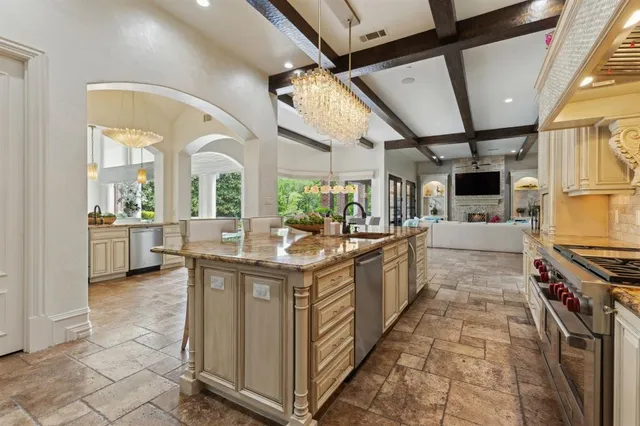 a large white kitchen with a large window