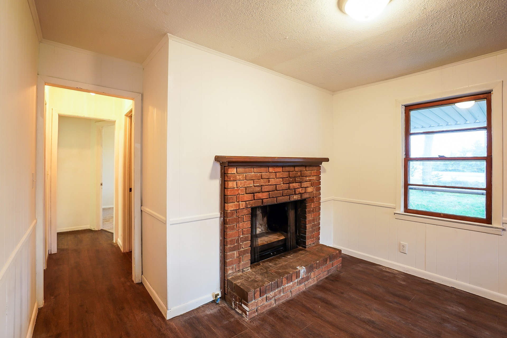 231 Foston Chapel Road Hopkinsville, KY 42240 - Photo 16 of 20 a view of an empty room with wooden floor and a fireplace