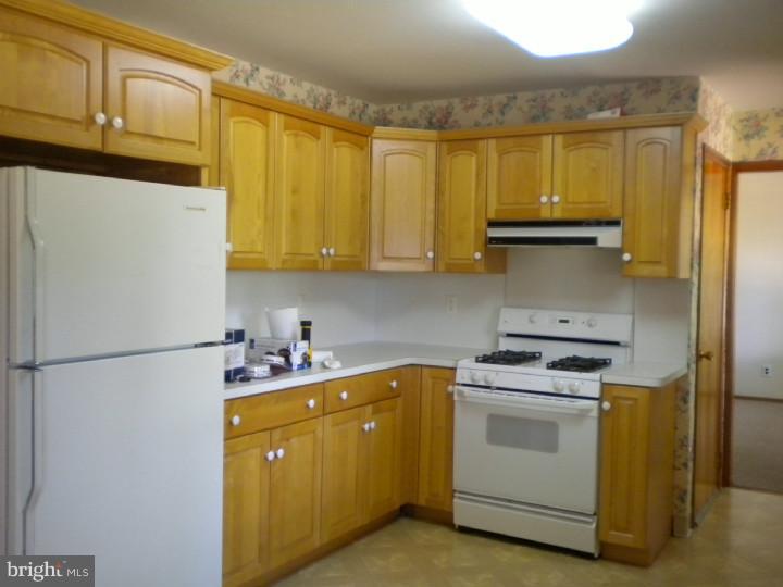 32 Cold Spring Road Mercerville, NJ 08619 - Photo 7 of 16 a kitchen with a sink a stove and a refrigerator