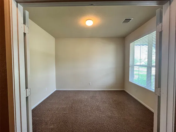 an empty room with windows and yard