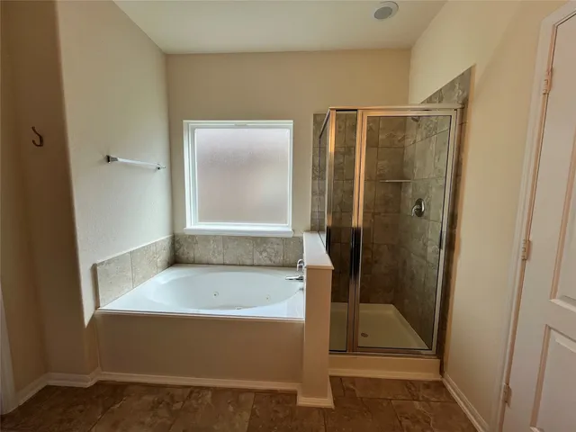 a bathroom with a tub and shower