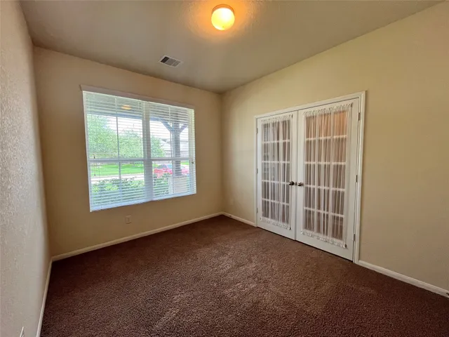 an empty room with windows and yard