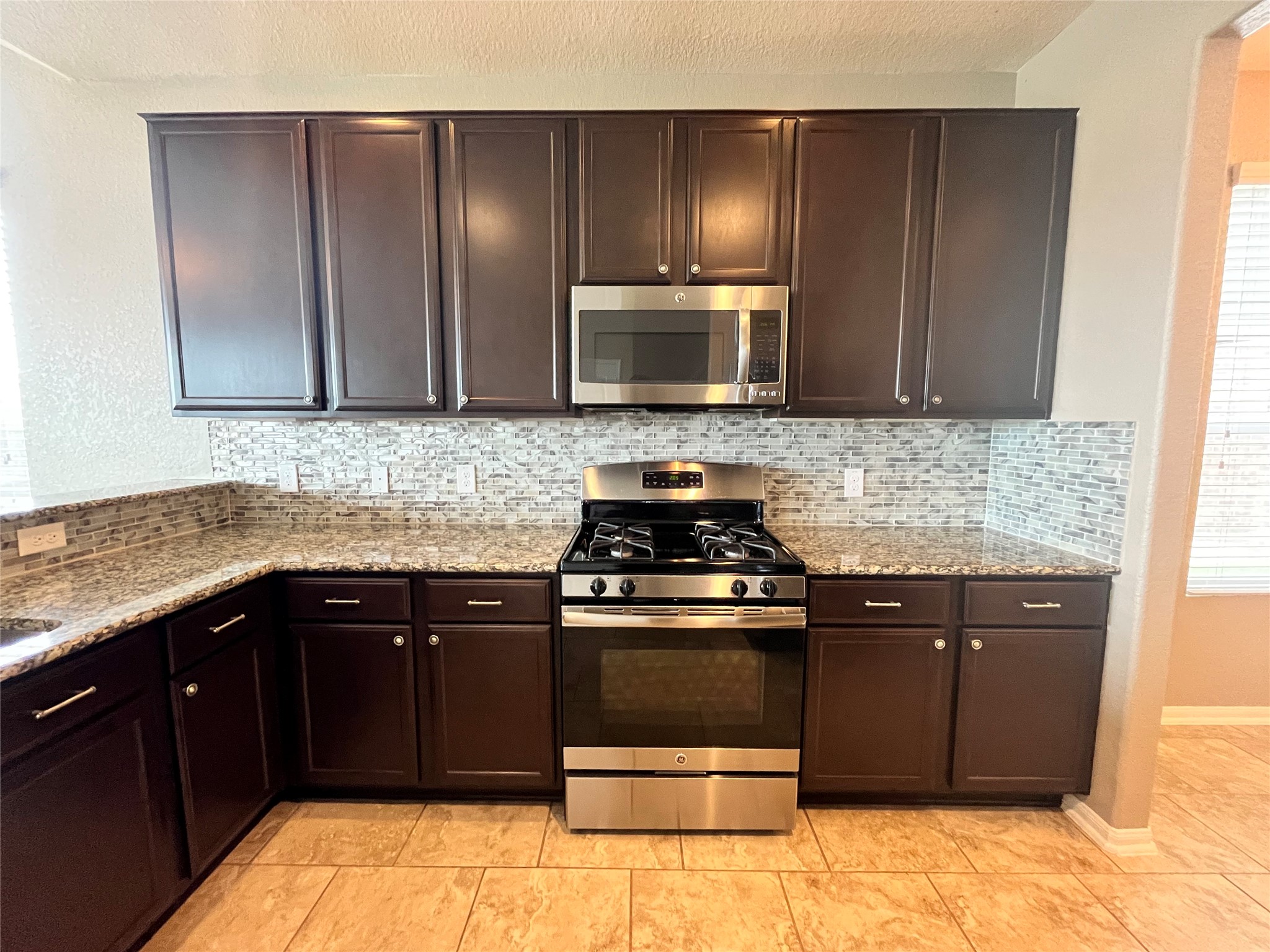 15103 Signal Ridge Way Cypress, TX 77429 - Photo 7 of 38 a kitchen with a sink stove and microwave