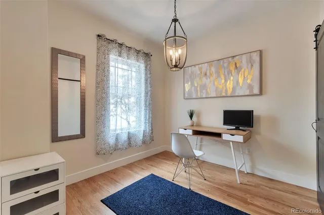 a workspace with wooden floor and a window