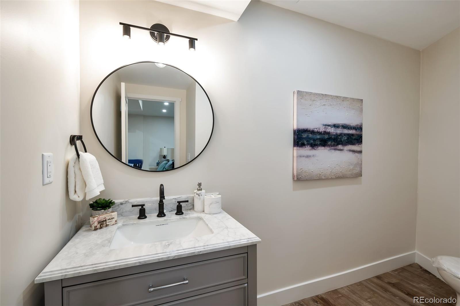 1417 Monroe Street Denver, CO 80206 - Photo 25 of 31 a bathroom with a sink and a mirror