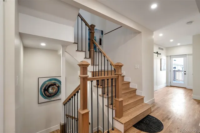 a view of entryway and hall with wooden floor