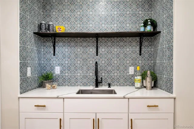 a kitchen with stainless steel appliances granite countertop a sink refrigerator and stove