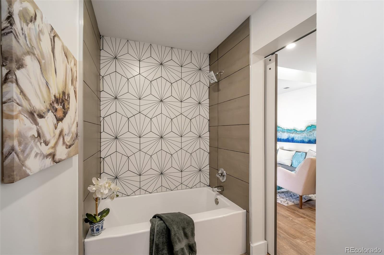 1417 Monroe Street Denver, CO 80206 - Photo 30 of 31 a bathroom with a bathtub and shower