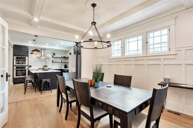 a dining room with a wooden table and chairs