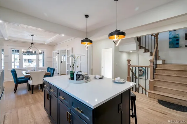 a kitchen that has a lot of cabinets in it and wooden floor