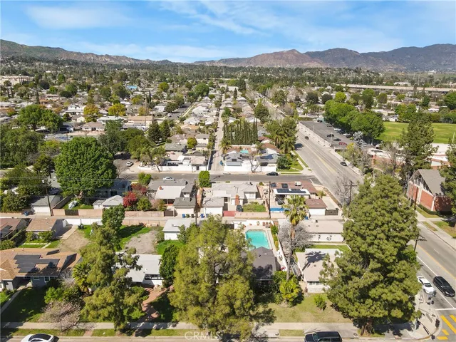 an aerial view of residential building with outdoor space and trees