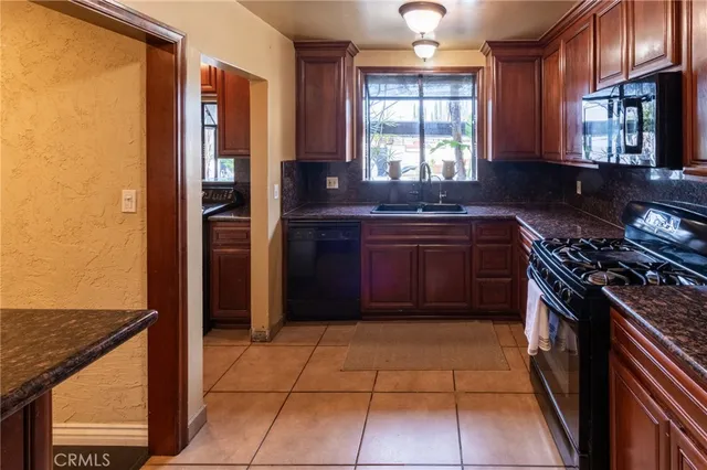 a kitchen with stainless steel appliances granite countertop a stove and a refrigerator