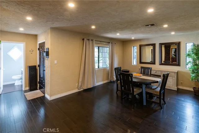 a view of a a dining room with furniture window and wooden floor