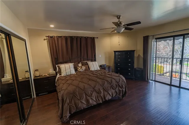 a bed sitting in a spacious bedroom next to a window