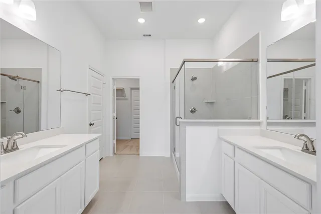 a bathroom with a shower sink and mirror