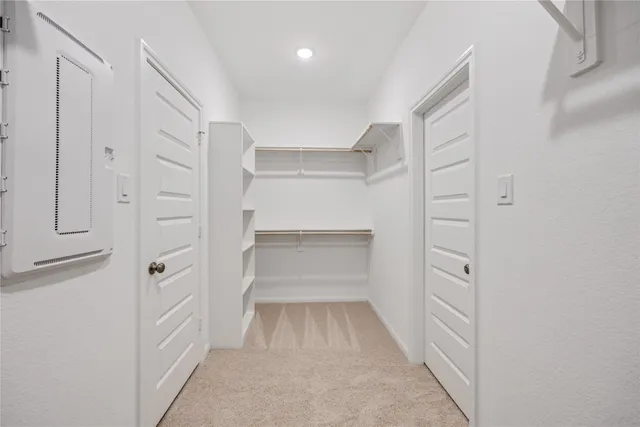 a view of walk in closet with white walls