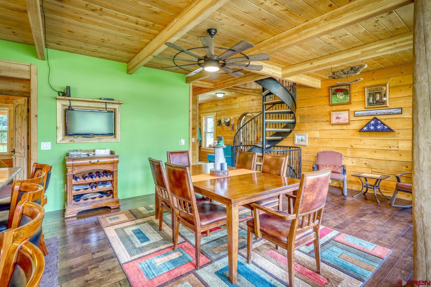 228 Estates Circle Road Pagosa Springs, CO 81147 - Photo 16 of 35 a dining room with furniture and a flat screen tv
