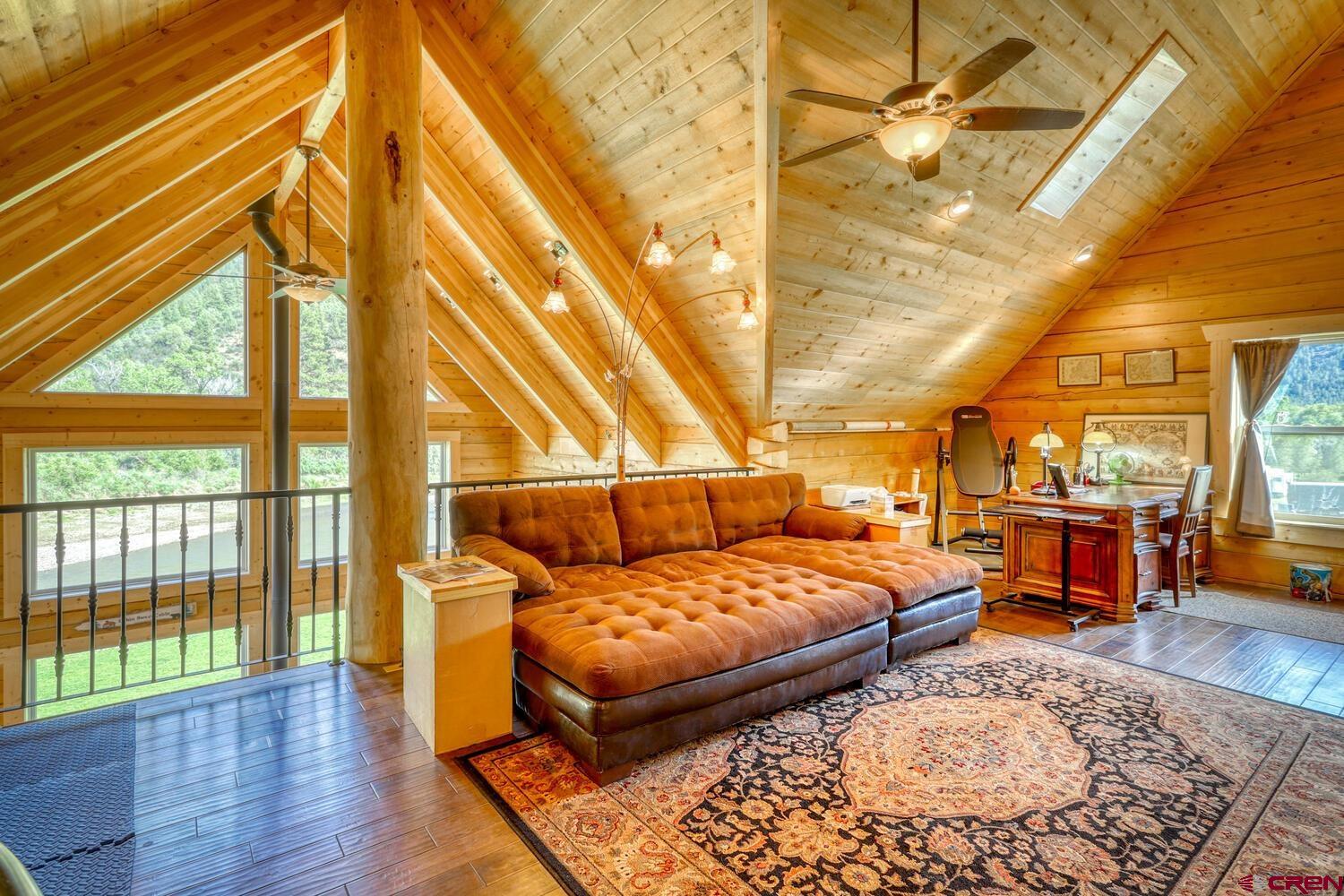 228 Estates Circle Road Pagosa Springs, CO 81147 - Photo 26 of 35 a bedroom with a bed and wooden floor