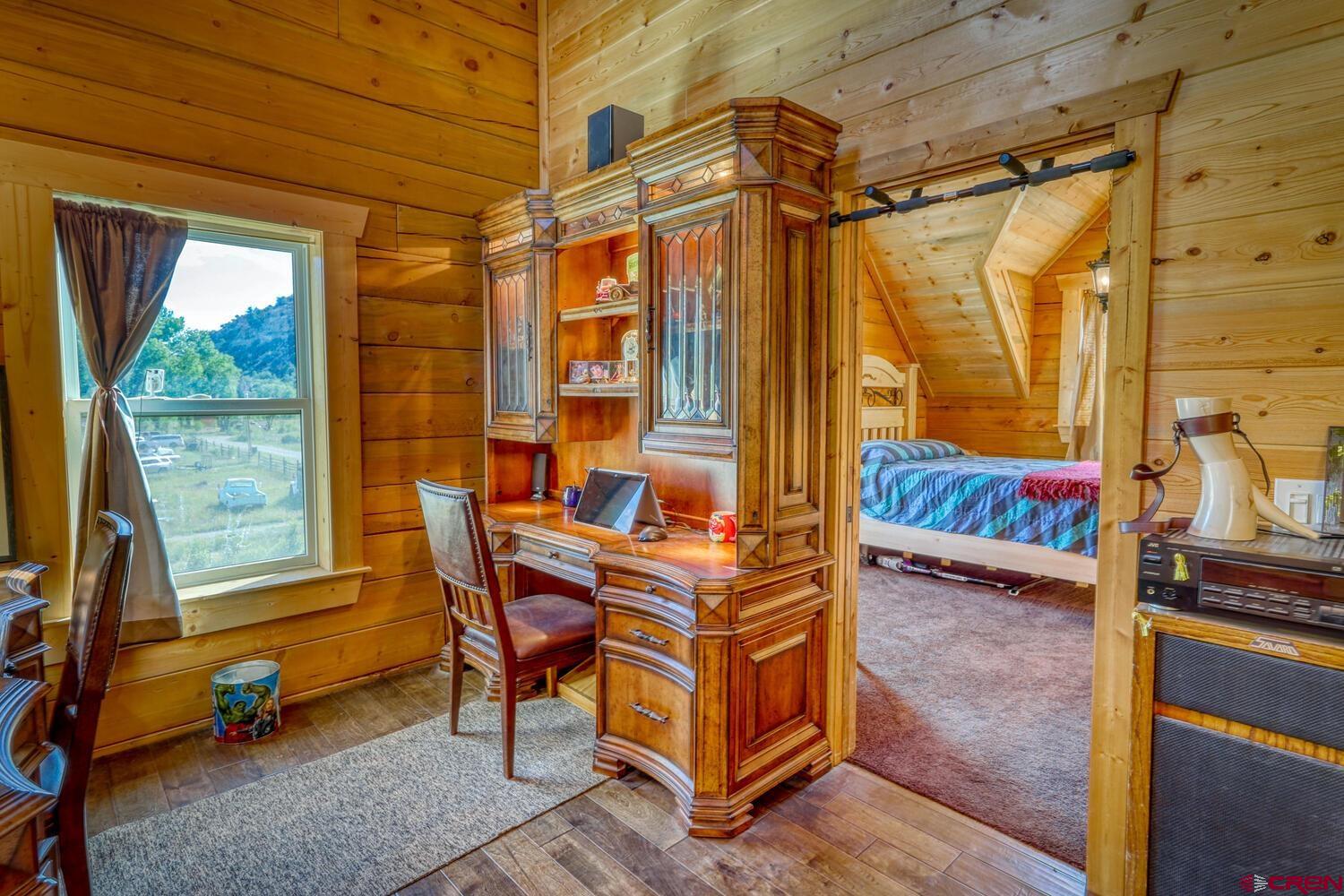 228 Estates Circle Road Pagosa Springs, CO 81147 - Photo 28 of 35 a bedroom with a bed and a window