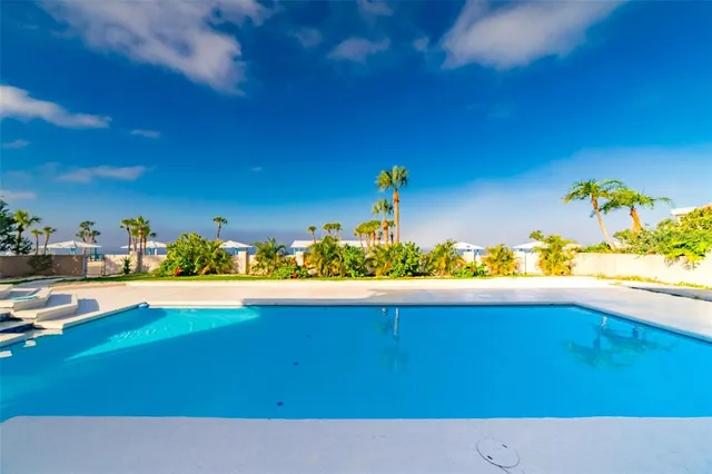 a view of a livingroom with a ceiling fan window and wooden floor